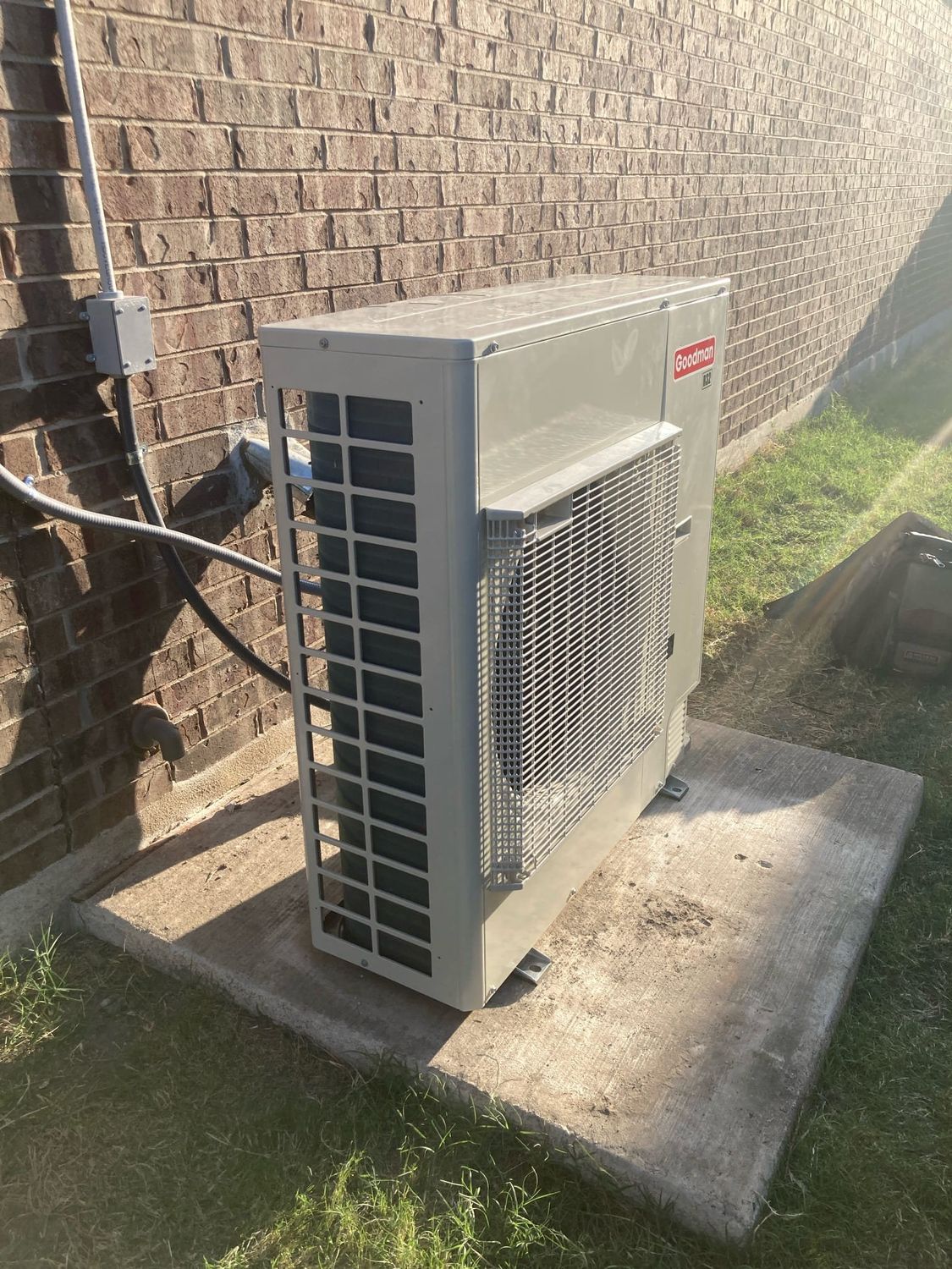 A ductless mini-split condenser installed outside a home