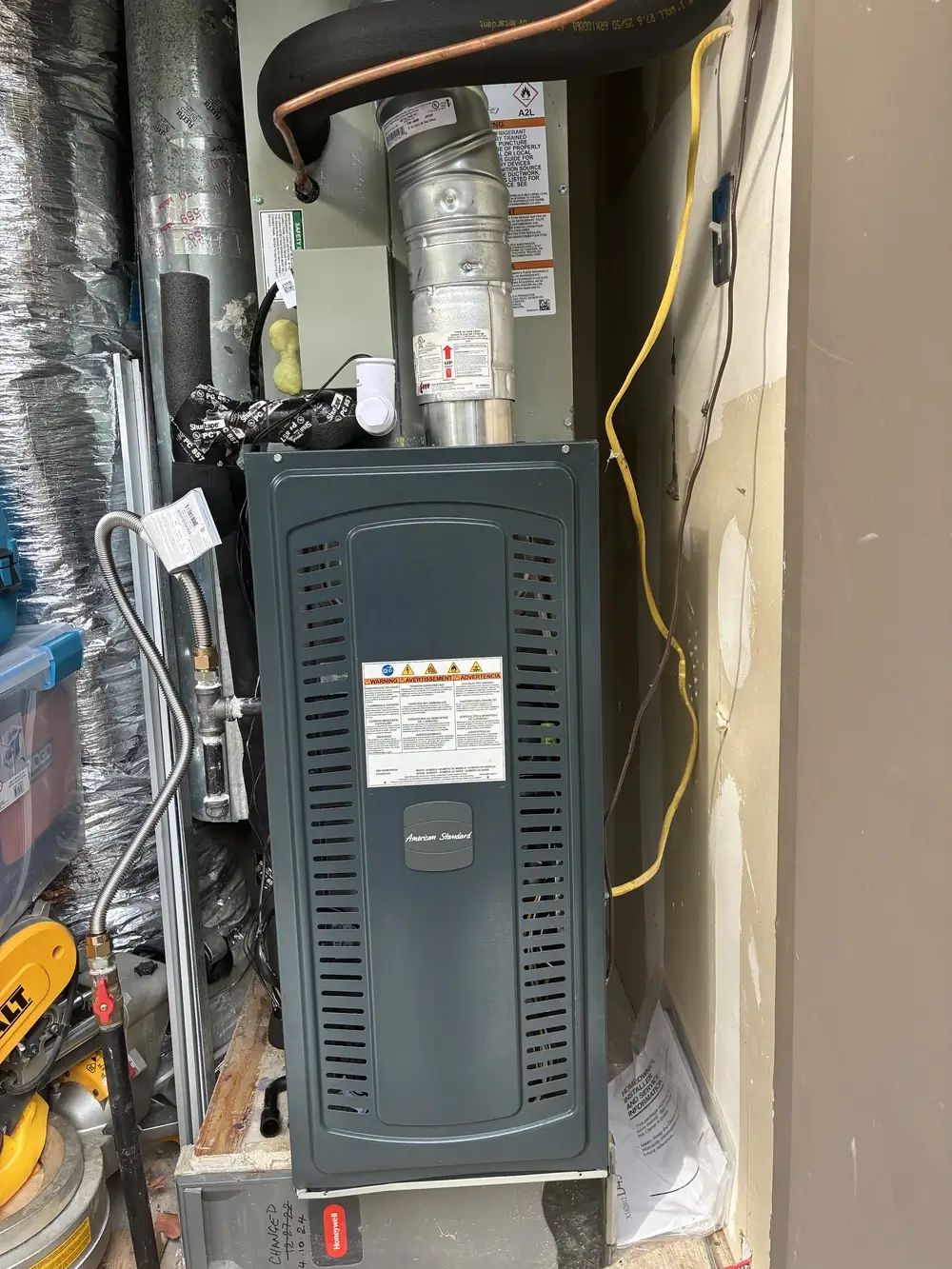 A newly installed furnace and air handler in a utility closet